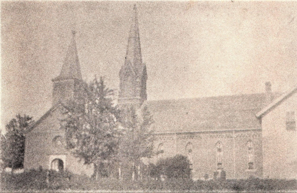 The old church (left), new church (center), and first school building (right)